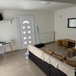 Renovated living room of a 110 sq.m. detached house in Alepou, Corfu, showcasing modern furnishings.