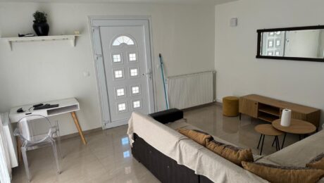 Renovated living room of a 110 sq.m. detached house in Alepou, Corfu, showcasing modern furnishings.