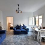 Interior of the apartment’s open-plan lounge and kitchen, blending rustic charm with contemporary features