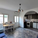 Interior of the apartment’s open-plan lounge and kitchen, blending rustic charm with contemporary features