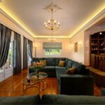 Open-concept living area with fireplace and direct garden access in villa