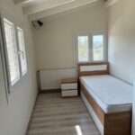 Well-appointed bedroom in a 110 sq.m. house in Alepou, Corfu, featuring a warm and inviting atmosphere.