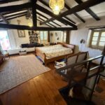 Cozy bedroom with wooden floors and traditional details in the detached house in Kato Korakiana