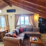 Modern open-plan living room with natural light in Potamos apartment for sale, Corfu