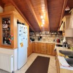 Fully equipped contemporary kitchen with breakfast bar in renovated Potamos apartment