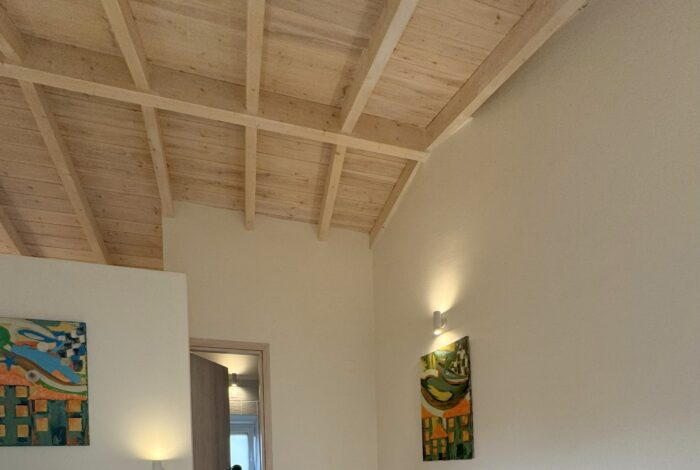 First floor bedroom with wooden ceiling and natural light
