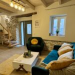 Spacious living room with a wooden staircase to the first floor