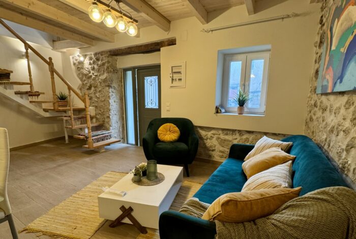 Spacious living room with a wooden staircase to the first floor