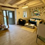 Ground floor open plan lounge-kitchen with stone walls