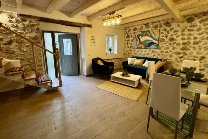 Ground floor open plan lounge-kitchen with stone walls