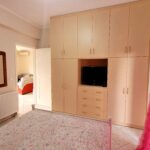 Bright bedroom with balcony access and countryside views in Corfu property