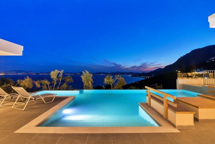 Nighttime ambiance by the pool with sea in the background
