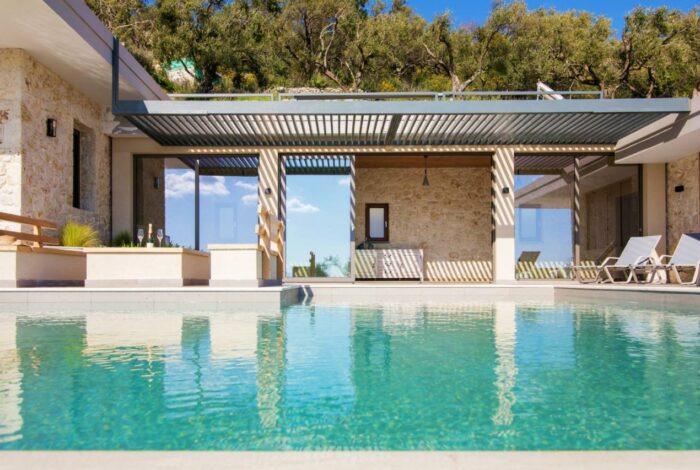 Traditional stone architecture blending with natural Corfu landscape
