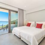 Spacious bedroom with sea-facing balcony in Corfu stone villa