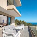 Terraced patio with lounge seating and sea views
