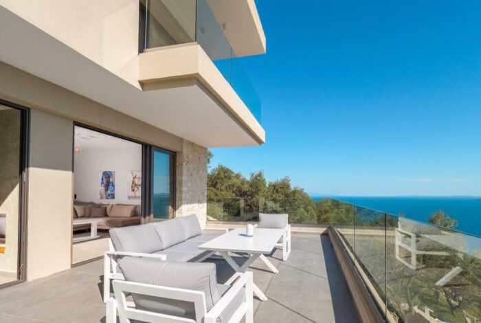 Terraced patio with lounge seating and sea views