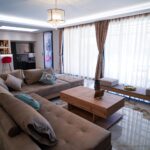 Open-plan lounge and dining area in Corfu villa with modern furnishings