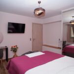 Double bedroom with TV and mirror wardrobe