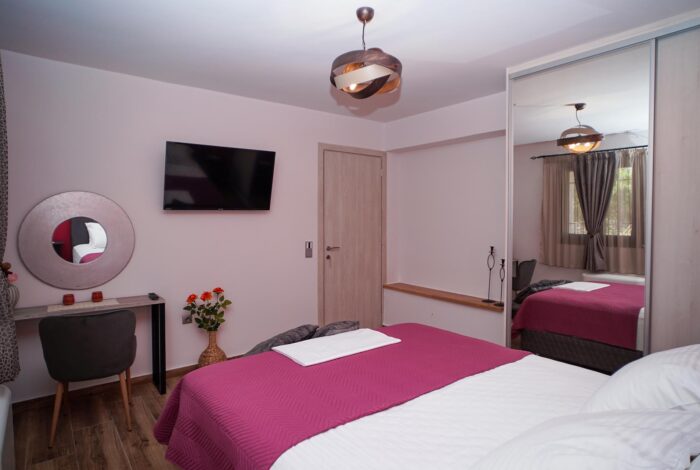 Double bedroom with TV and mirror wardrobe