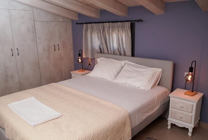 Guest bedroom with serene views of the garden and pool in Corfu villa