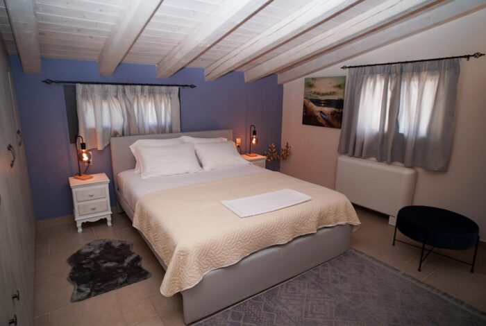 Bright bedroom with stylish décor and pool view in Corfu villa