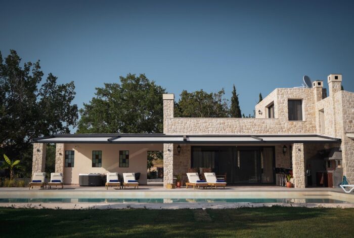 Garden space with lush greenery and pool area in Corfu villa