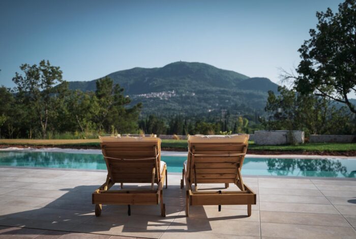 Sunbeds and poolside lounge area in Corfu villa