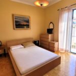 Spacious bedroom with large window and peaceful cityscape views in Corfu Town