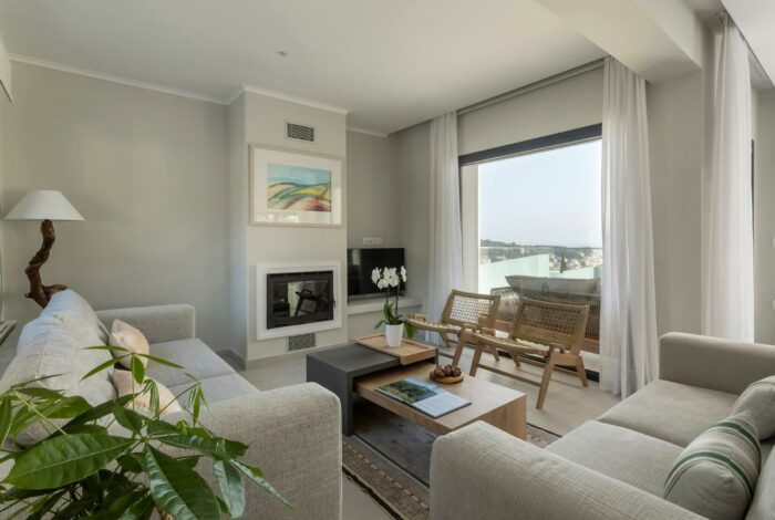 Spacious living room with elegant fireplace and panoramic sea views in luxury villa