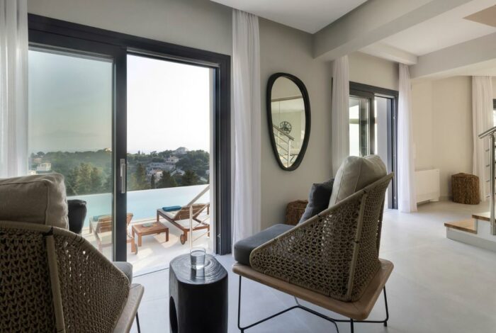 Open-plan dining area with modern furnishings and large windows showcasing stunning views
