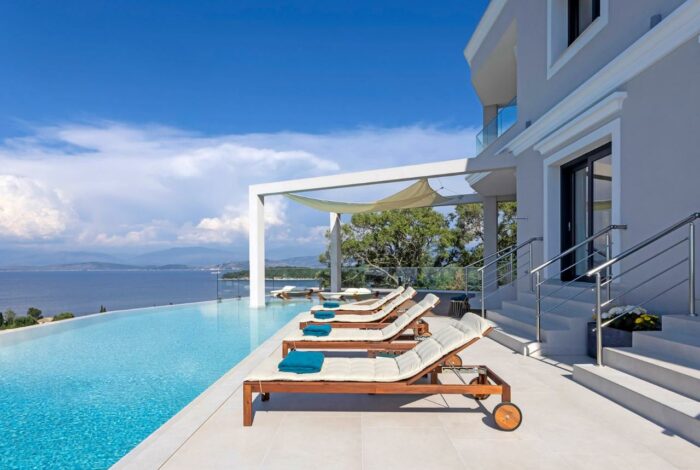 Outdoor lounging area with sunbeds and sea views in Kassiopi villa