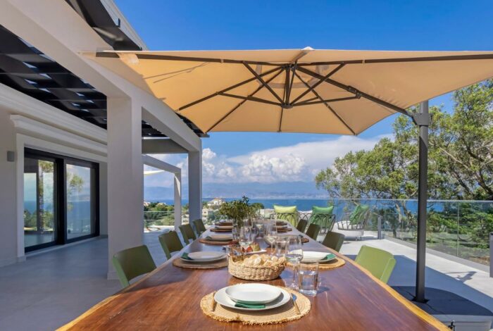 Private terrace with dining area, perfect for al fresco meals overlooking the sea
