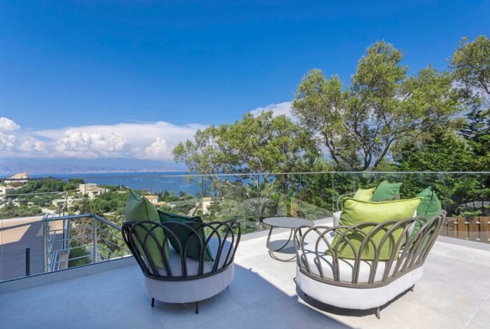 Outdoor terrace with lounge furniture overlooking the sea and the Albanian coast