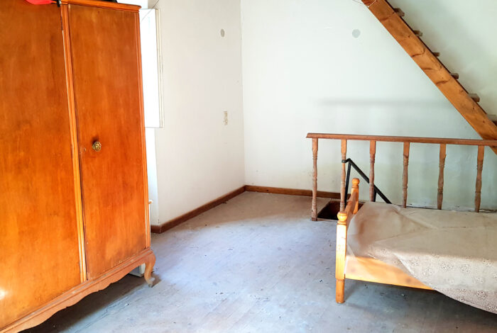 First-floor bedroom with natural light in traditional Corfu house for sale