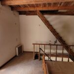 Wooden staircase connecting upper floor and attic in Corfu renovation property