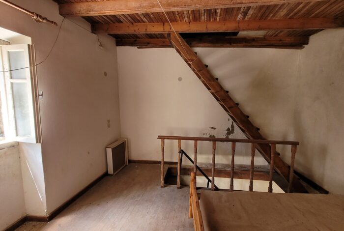 Wooden staircase connecting upper floor and attic in Corfu renovation property