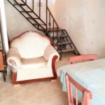 Open plan kitchen and living area in need of full renovation in Chlomos property