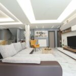 Stylish open-plan living room with large windows and natural light