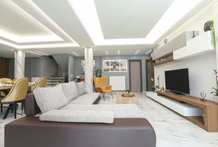 Stylish open-plan living room with large windows and natural light