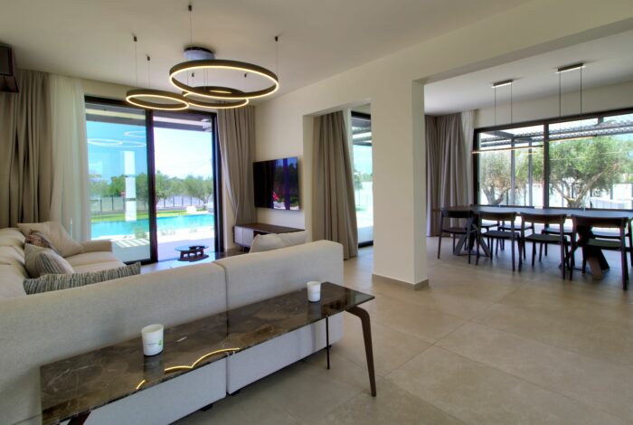 Elegant dining area with floor-to-ceiling windows overlooking pool