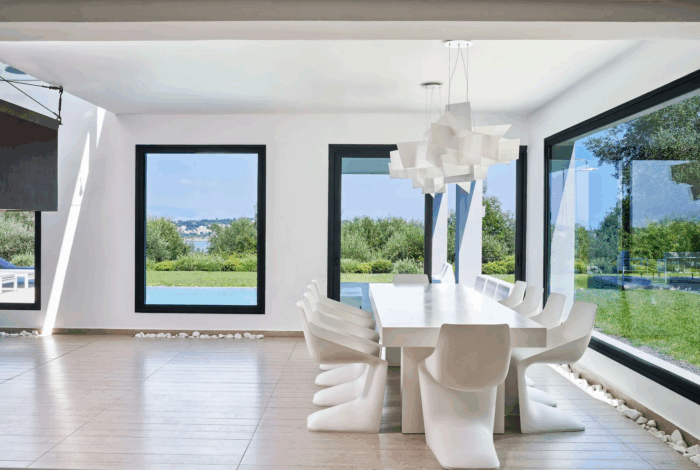 Spacious dining area with natural light and pool views in Corfu luxury home