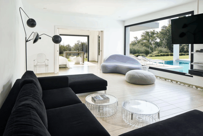 Open-plan living and dining space with designer furniture and panoramic views