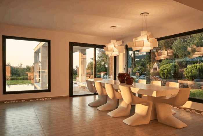 Open-plan living and dining space with designer furniture and panoramic views
