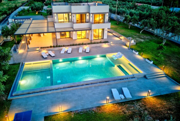 Exterior night shot of Corfu villa with 200 sqm living space and olive trees