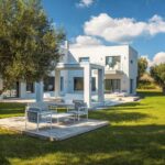 Covered outdoor dining area with sea and countryside views in luxury Viros villa