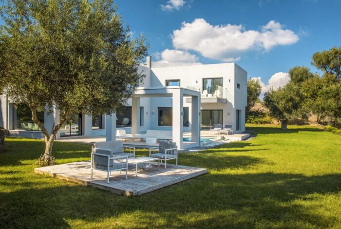 Covered outdoor dining area with sea and countryside views in luxury Viros villa