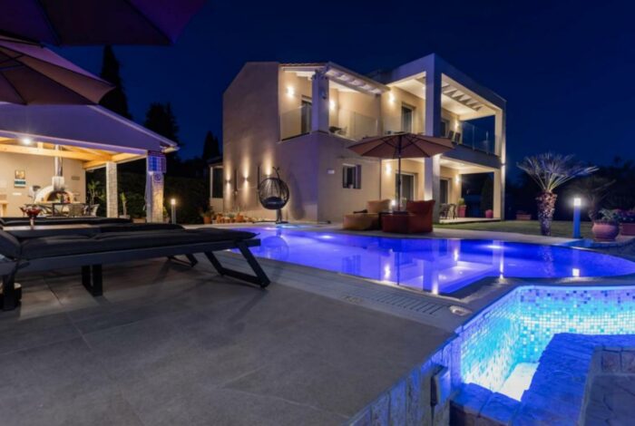 Dimming lights of villa exterior and swimming pool