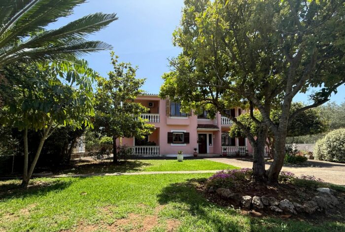 Front exterior view of detached house in Linia, Corfu, surrounded by greenery