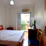 Second bedroom with balcony and air conditioning unit