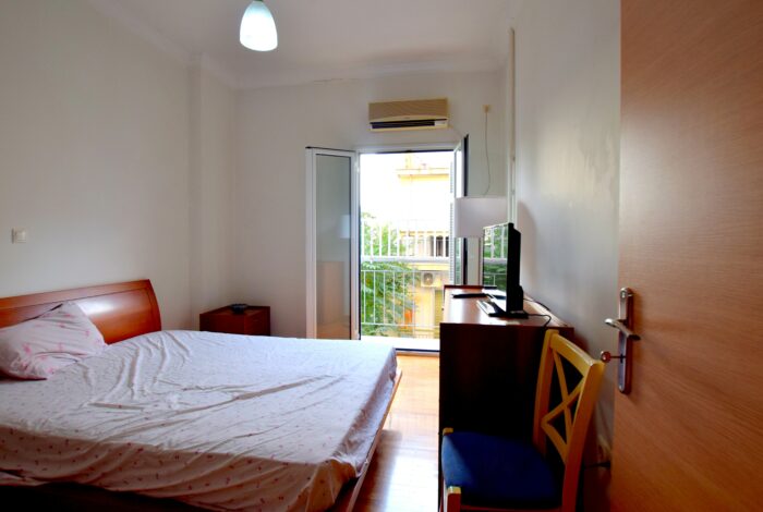 Second bedroom with balcony and air conditioning unit